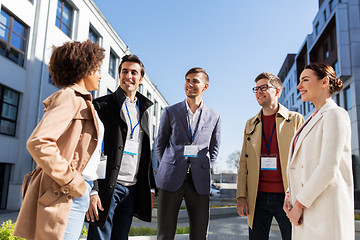 Image showing business people with conference badges in city