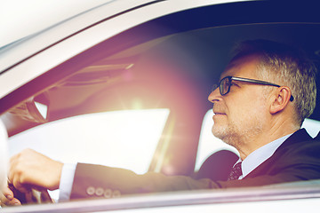 Image showing happy senior businessman driving car