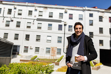 Image showing happy man with coffee in paper cup on city street