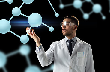 Image showing scientist in lab coat and goggles with molecules