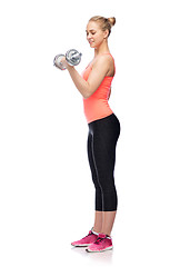 Image showing sportive woman flexing muscles with dumbbell