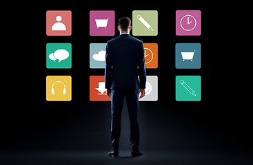 Image showing businessman in suit looking at virtual menu icons