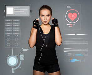 Image showing woman with earphones listening to music in gym