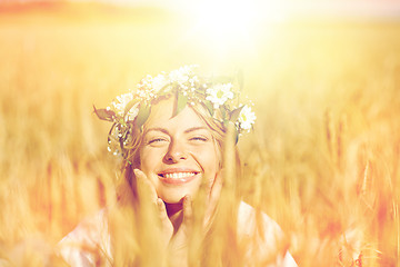 Image showing happy woman in wreath of flowers on cereal field