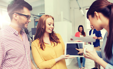 Image showing creative team with tablet pc talking at office