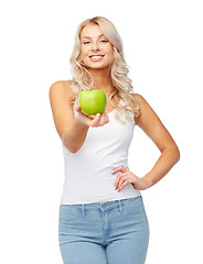 Image showing happy beautiful young woman with green apple