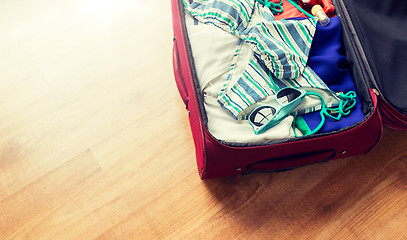 Image showing close up of travel bag with beach clothes