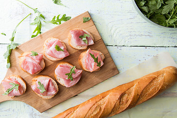 Image showing Bread with ham on board