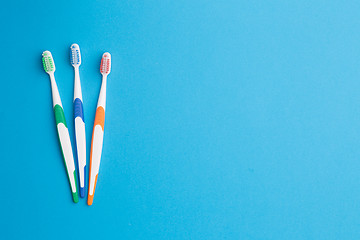 Image showing Toothbrushes at empty blue background