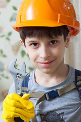 Image showing Boy in a protective helmet and with a wrenc
