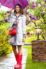 Image showing Beautiful woman with an umbrella in the park.