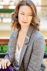 Image showing woman in gray jacket with dragonfly brooch