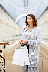 Image showing woman with packages in city shopping center