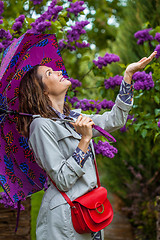 Image showing smiling middle-aged woman with an umbrella 