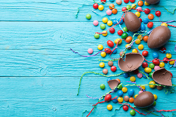 Image showing Candy, chocolate eggs, colorful ribbons