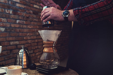 Image showing Barista brewing coffee