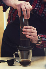 Image showing Barista brewing aeropress coffee