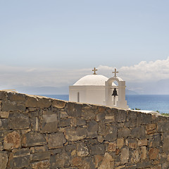 Image showing Greek orthodox church behind the wall