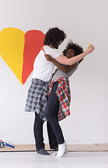 Image showing couple with painted heart on wall