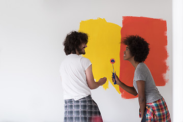 Image showing multiethnic couple painting interior wall