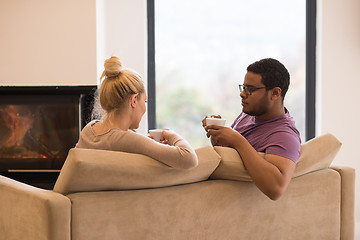 Image showing Young multiethnic couple  in front of fireplace