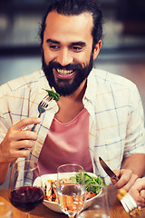 Image showing happy man having dinner at restaurant