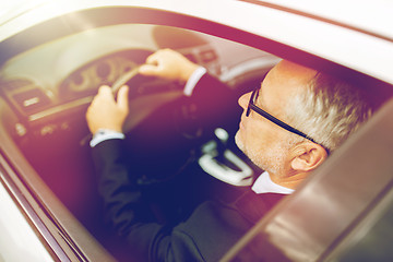 Image showing happy senior businessman driving car