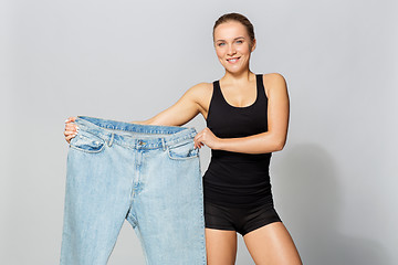 Image showing young slim sporty woman with oversize pants