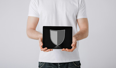 Image showing man with antivirus program icon on tablet pc