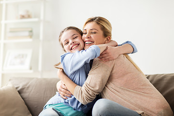 Image showing happy smiling family hugging on sofa at home