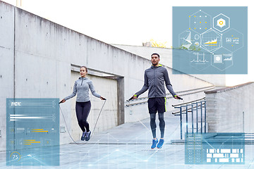 Image showing man and woman exercising with jump-rope outdoors