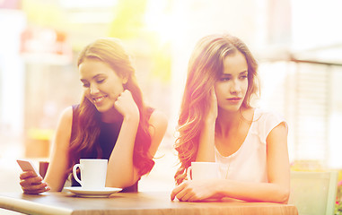 Image showing women with smartphones and coffee at outdoor cafe