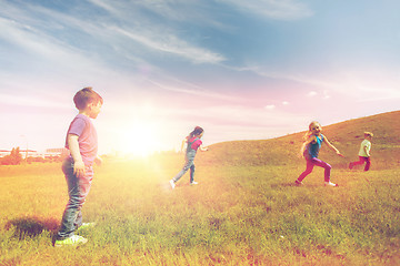 Image showing group of happy kids running outdoors