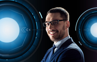 Image showing smiling businessman in glasses over black