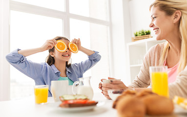Image showing happy family having breakfast at home kitchen