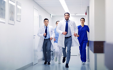 Image showing group of medics walking along hospital