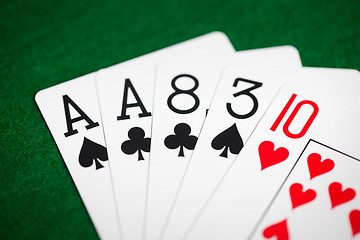 Image showing poker hand of playing cards on green casino cloth