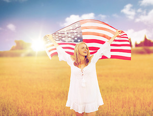 Image showing happy woman with american flag on cereal field