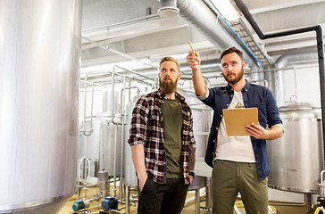 Image showing men with clipboard at craft brewery or beer plant