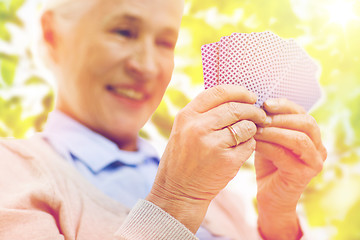 Image showing close up of happy senior woman playing cards