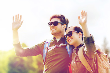 Image showing happy couple with backpacks hiking outdoors