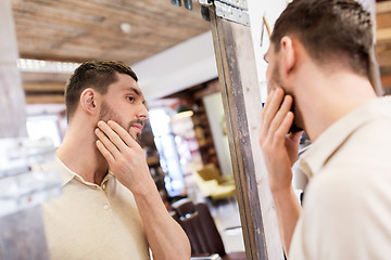 Image showing man looking at himself at barbershop mirror