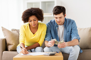 Image showing couple with papers and calculator at home