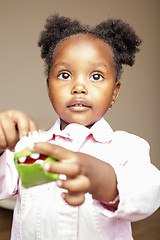 Image showing little cute african american girl playing with animal toys at home, pretty adorable princess in interior happy smiling, lifestyle people concept