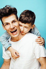 Image showing young pretty man model with little cute son playing together, lifestyle modern people concept, family male