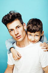 Image showing young pretty man model with little cute son playing together, lifestyle modern people concept, family male