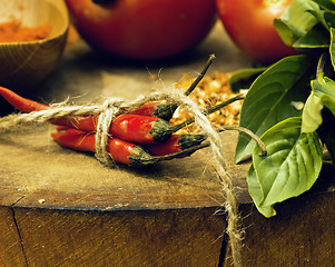 Image showing vegetables on wooden kitchen with spicies, tomato, chilli, green