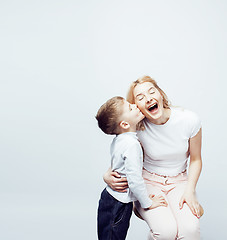 Image showing young modern blond curly mother with cute son together happy smiling family posing cheerful on white background, lifestyle people concept, sister and brother friends 