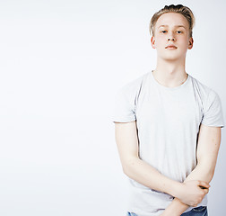 Image showing young handsome teenage hipster guy posing emotional, happy smiling against white background isolated, lifestyle people concept 