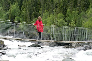 Image showing Woman on suspension bridge